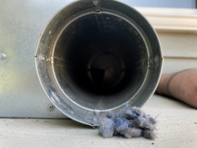 Plainfield Dryer Vent Cleaning technician using specialized equipment to clear severe dryer vent blockage in Plainfield